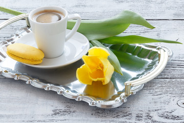 Bunch of yellow tulips on table with coffee