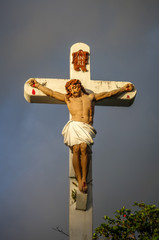 Statue of Jesus Christ on the cross near Haapiti church in Moorea island