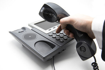 Making a call, Businessman is dialing IP telephone keypad