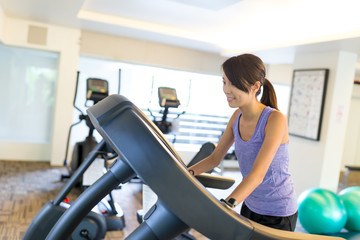 Fototapeta premium Woman running on treadmill