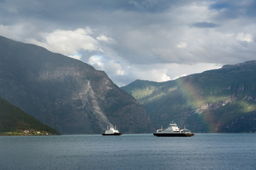 Fjord ferries and rainbow landscape.