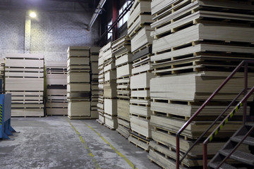 Factory warehouse.Plywood,wood,pallets.Photo toned in retro style.