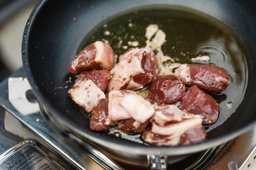 Chef Fried Marinated Diced Raw Beef in Pan with Rosemary Oil with Spoon.