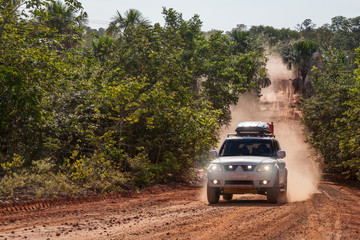 Obraz na płótnie Canvas JALAPAO, BRAZIL - JANUARY 2017 - Dust cloud of an offroad vehicle on january 5th, 2017. Tourist driving at Jalapao State Park, Tocantins, Brazil.