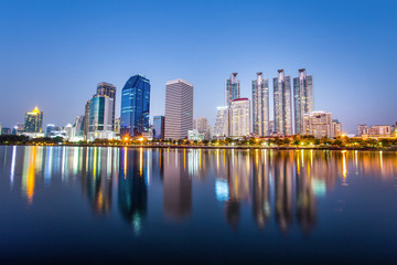 Fototapeta na wymiar BANGKOK, THAILAND, FEBRUARY 11, 2017 - Panorama of cityscape with skyscrapers and sky line by night from Benjakitti Park in Bangkok, Thailand