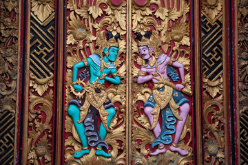 Fototapeta na wymiar carved detail mythological god on Balinese temple door