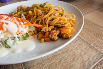 Spaghetti with minced beef tomato sauce and fresh basil on wooden table with copy space