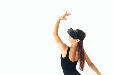 Sport athlete girl with a beautiful figure dancing with glasses of virtual reality. Future technology concept. Modern imaging technology. Conceptual image of a virtual dance and other sports.