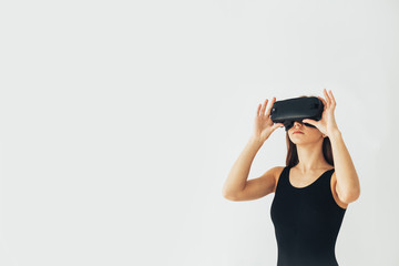 Sport athlete girl with a beautiful figure with glasses of virtual reality. Future technology concept. Modern imaging technology. Conceptual image of virtual sports. Sports simulator.