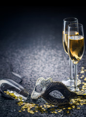 mask and champagne with star shaped confetties