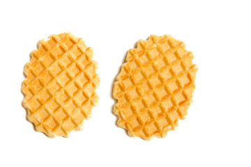 Two golden round waffles isolated over white background.