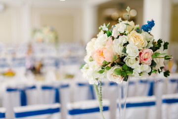 Vase with flowers on the wedding table