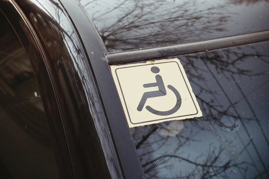 Disabled sign on the car glass. Macro shot.