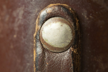 Metal rivets on a leather pouch