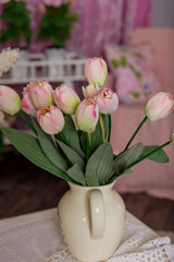 Beautiful pink tulips stand in a white vase
