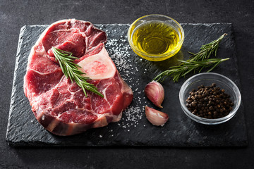 Raw meat on black slate background. Top view.
