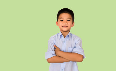 Smart Asian boy isolated on green background.