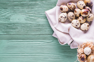 Easter card. Quail eggs on wooden background with copy space. Easter eggs. 