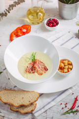 Cream soup with parmesan and bacon and crackers