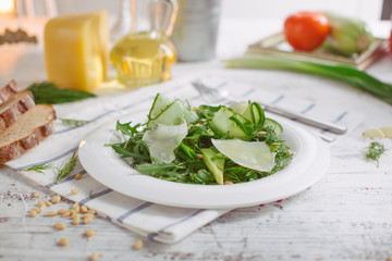 Obraz na płótnie Canvas vegetarian Green salad with Parmesan arugula avocado nuts