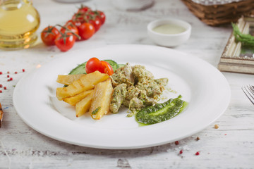 Chicken and potatoes with pickled cucumbers, greens