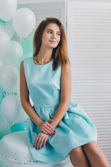 Fototapeta premium Girl in turquoise dress with balloons
