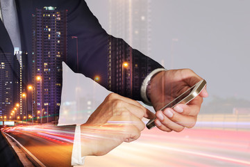 Double exposure of businessman use smartphone, light trails on the street and urban in the night as business, Technology, telecommunication and Communication concept.
