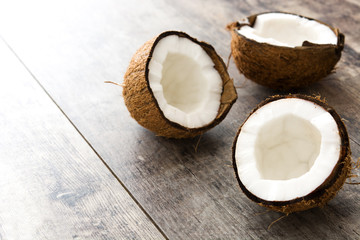 Fototapeta na wymiar Half coconuts fruit on wooden background 