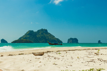 Poda island (Koh Poda) beach with traditional thai longtail boat and islands in Andaman sea, Krabi province, Thailand