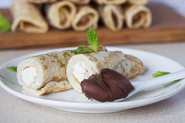 Breakfast from cooked curd rolls pancakes with chocolate close