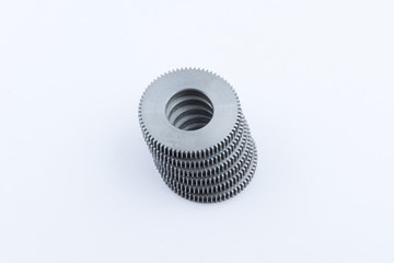 Isolated metal pinions gear. The iron gear on a white background. Pinions in the gearbox. Parts to...