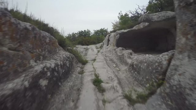 Epic Aerial view of Eski-Kermen. The ruins of the ancient city Mangup Kale. Cloudy sky evening. Mountain Mangup, Crimea. 