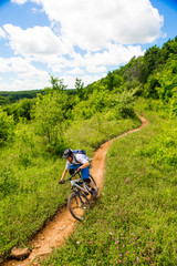 Man riding his mountain bike on a single track trail