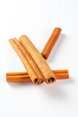 cinnamon sticks isolated on white background, close up