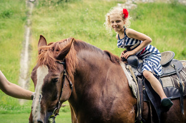 child riding a horse