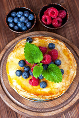 Golden crepes with  raspberry and blueberry
