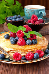 Crepes with  fresh berries. Pancakes stack with raspberry,, blueberry and syrup