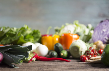 Young spring vegetables on black wood. Background with place for text
