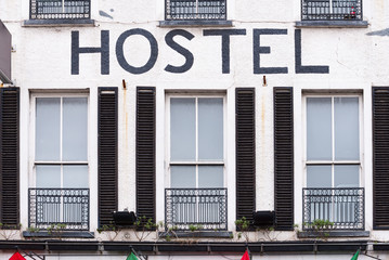 Facade of an older hostel with faux balconies