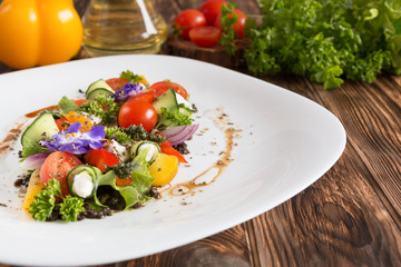 Greek salad fresh vegetables with feta cheese and grated black olives.