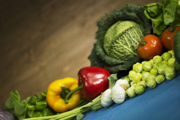 Young spring vegetables on  wood. Background layout with free text space.