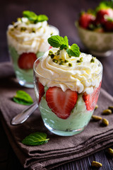 Pistachio pudding with strawberries and whipped cream