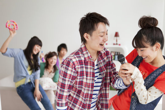 Young people fighting over microphone