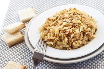 Fried cabbage with caraway and garlic on a plate