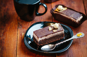 Delicious chocolate cake on plate on table on wooden background