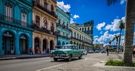 Fototapeta na wymiar HDR - Blauer Chevrolet Oldtimer auf der Hauptstraße in Havanna Kuba fährt vor dem Capitolio - Serie Kuba 2016 Reportage