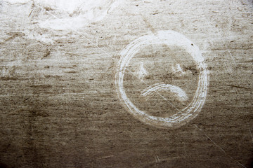 Painted sad smile on gray dusty background