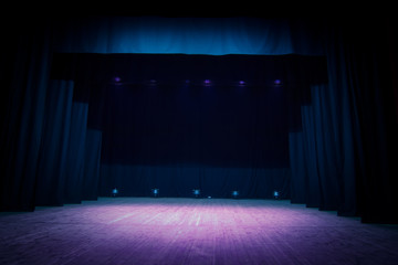 An empty stage of the theater, lit by spotlights before the performance