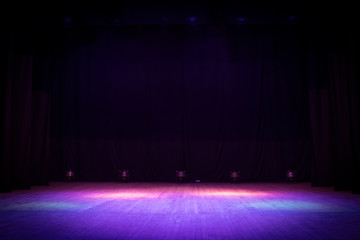 An empty stage of the theater, lit by spotlights before the performance - obrazy, fototapety, plakaty