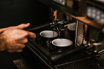 Fototapeta na wymiar Barista making a cup of coffee at the coffee shop